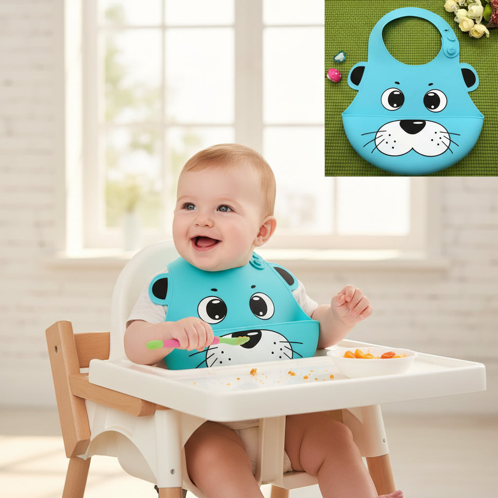 Blue cartoon-style silicone bib on a green surface with flowers in the background